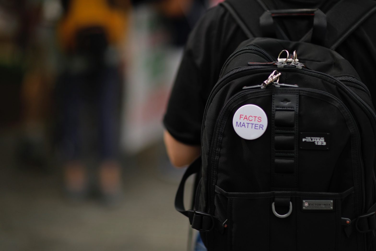 Facts Matter pin on a backpack