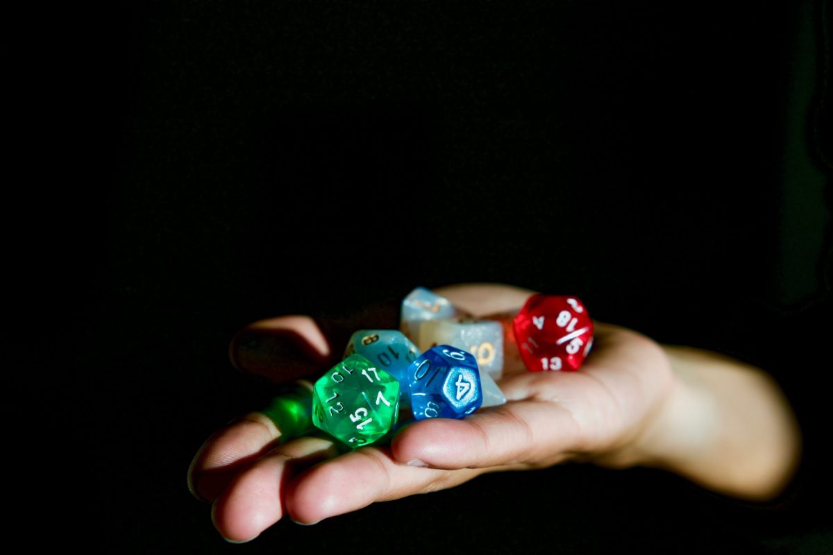 Hand holding Dungeons and Dragons polyhedral dice